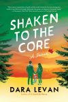 Book cover for the novel Shaken to the Core showing two people holding hands and a dog, silhouetted against a layered orange-to-green sunset framed by pine trees, with the book title displayed across the sky.